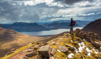 Benefits of nature Hike - better mood and less rumination Mountain scenery The silhouette of a hiker in a mountain wilderness scene in Scotland, UK.