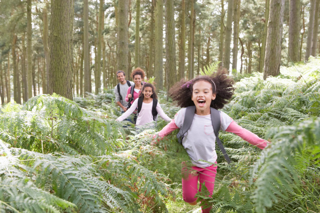 Want Happy, Healthy Children?  Take Them Outside [Study]. Family Group Hiking In Woods Together