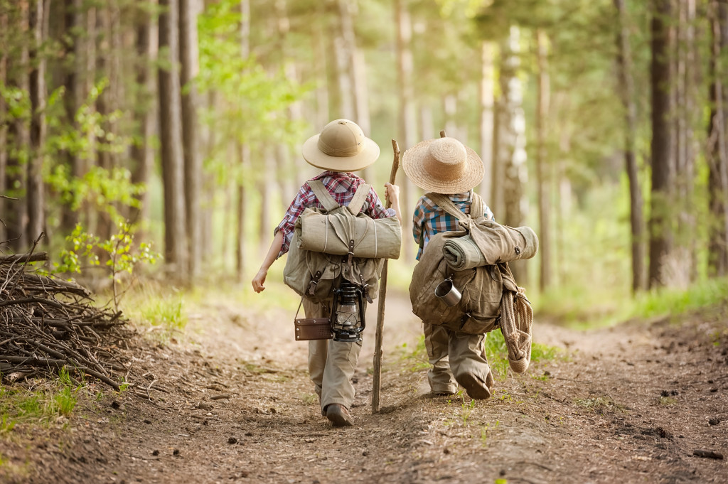 Tips for Hiking with Kids - Boys on a forest road with backpacks