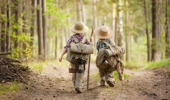 Tips for Hiking with Kids - Boys on a forest road with backpacks